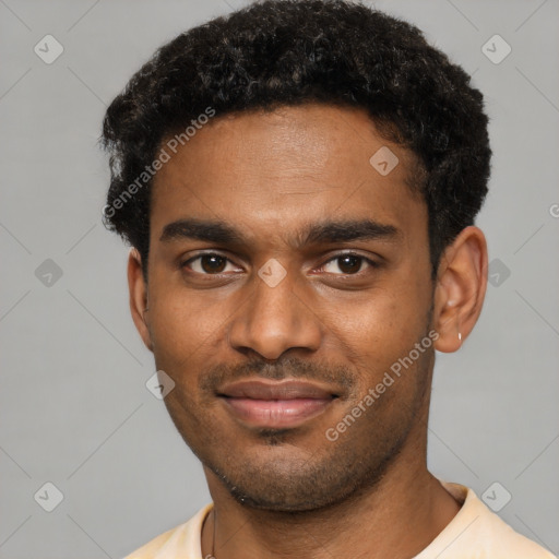 Joyful black young-adult male with short  brown hair and brown eyes