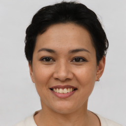 Joyful asian young-adult female with short  brown hair and brown eyes