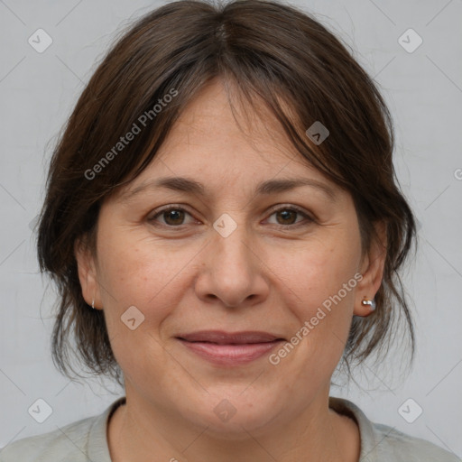 Joyful white adult female with medium  brown hair and brown eyes