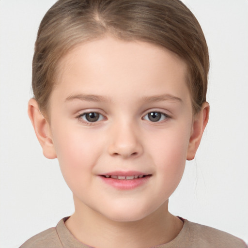 Joyful white child female with short  brown hair and brown eyes