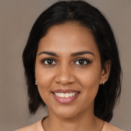 Joyful black young-adult female with medium  brown hair and brown eyes