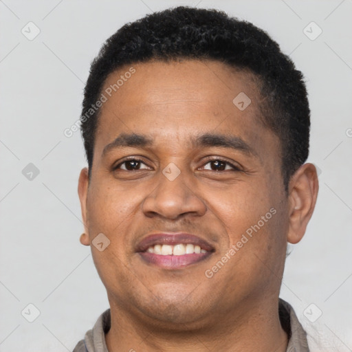 Joyful latino young-adult male with short  black hair and brown eyes