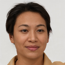 Joyful asian young-adult female with short  brown hair and brown eyes