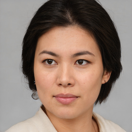 Joyful white young-adult female with medium  brown hair and brown eyes