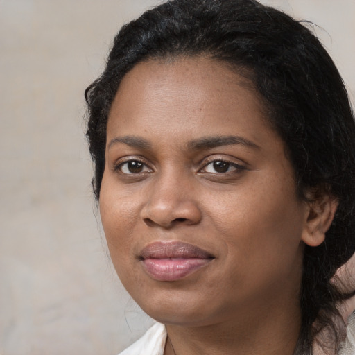 Joyful black young-adult female with medium  black hair and brown eyes