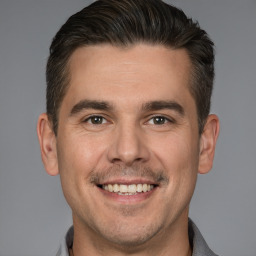 Joyful white adult male with short  brown hair and brown eyes