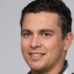 Joyful white adult male with short  brown hair and brown eyes