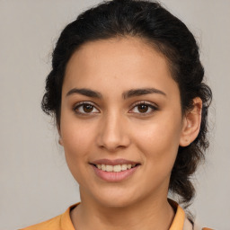 Joyful latino young-adult female with medium  brown hair and brown eyes