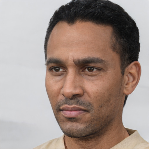Neutral latino adult male with short  black hair and brown eyes