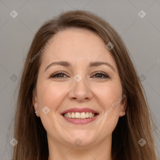 Joyful white adult female with long  brown hair and brown eyes