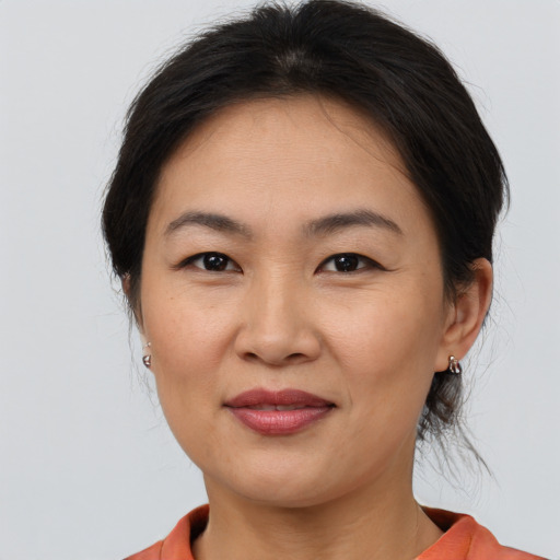 Joyful asian young-adult female with medium  brown hair and brown eyes