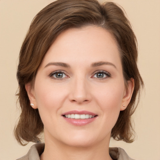 Joyful white young-adult female with medium  brown hair and brown eyes