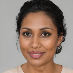 Joyful black young-adult female with medium  brown hair and brown eyes