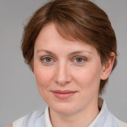 Joyful white young-adult female with medium  brown hair and blue eyes