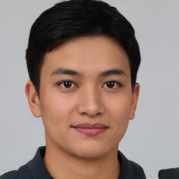 Joyful asian young-adult male with short  brown hair and brown eyes