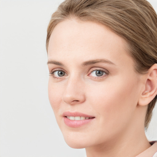 Joyful white young-adult female with medium  brown hair and blue eyes