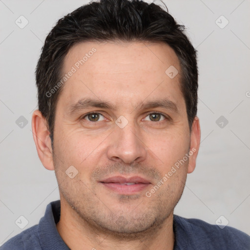 Joyful white adult male with short  brown hair and brown eyes