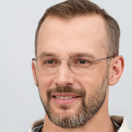 Joyful white adult male with short  brown hair and brown eyes