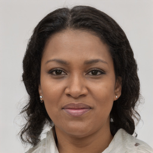 Joyful black young-adult female with medium  brown hair and brown eyes