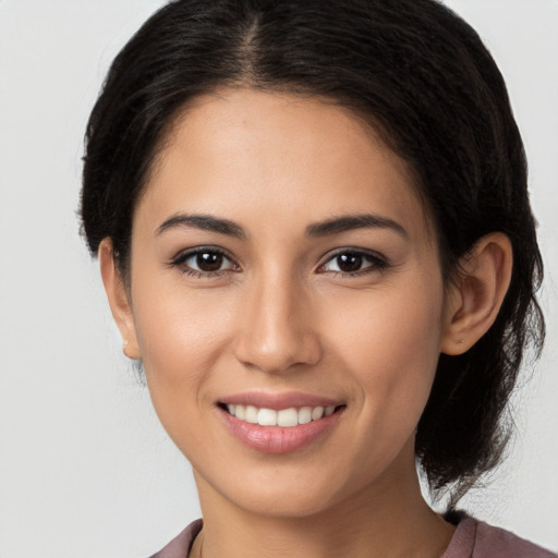 Joyful white young-adult female with long  brown hair and brown eyes