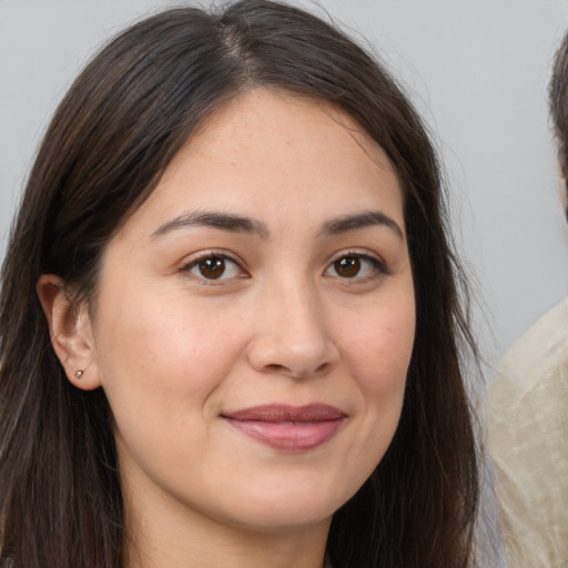 Joyful white young-adult female with long  brown hair and brown eyes