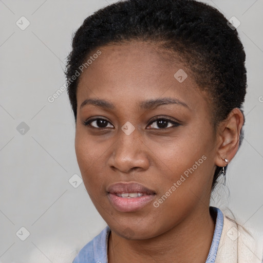 Joyful black young-adult female with short  black hair and brown eyes