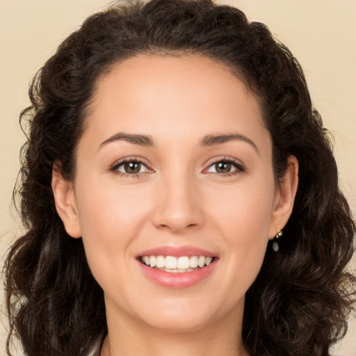 Joyful white young-adult female with long  brown hair and brown eyes