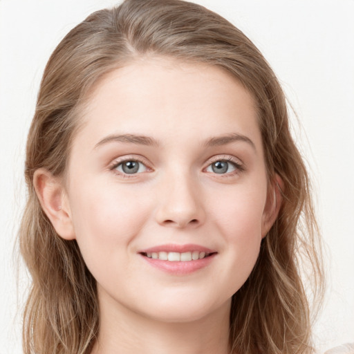 Joyful white young-adult female with long  brown hair and blue eyes