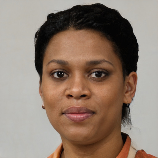 Joyful black young-adult female with short  black hair and brown eyes