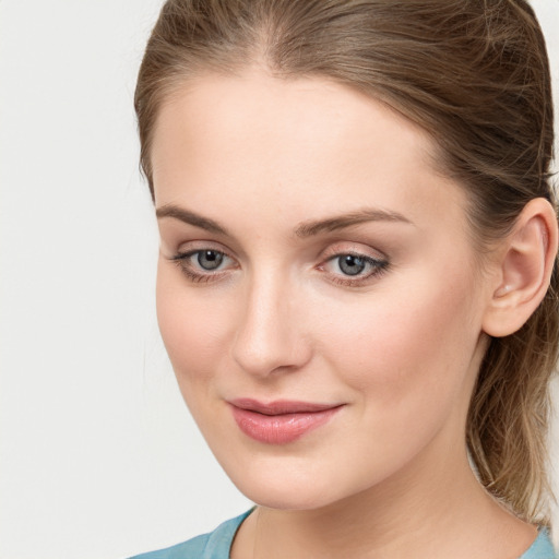 Joyful white young-adult female with medium  brown hair and blue eyes