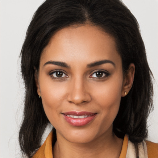 Joyful latino young-adult female with long  brown hair and brown eyes