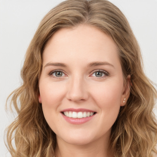 Joyful white young-adult female with long  brown hair and green eyes