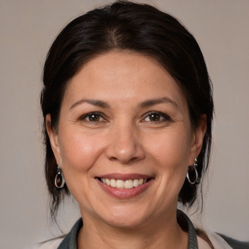 Joyful white adult female with medium  brown hair and brown eyes