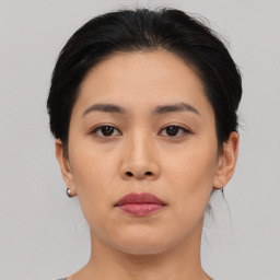 Neutral asian young-adult female with medium  brown hair and brown eyes