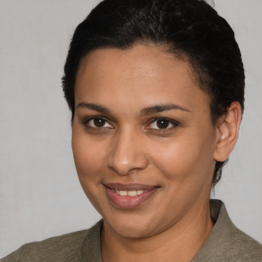 Joyful latino young-adult female with short  brown hair and brown eyes