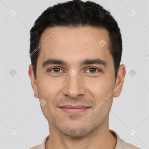 Joyful white young-adult male with short  black hair and brown eyes