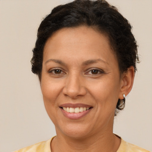Joyful latino adult female with short  brown hair and brown eyes