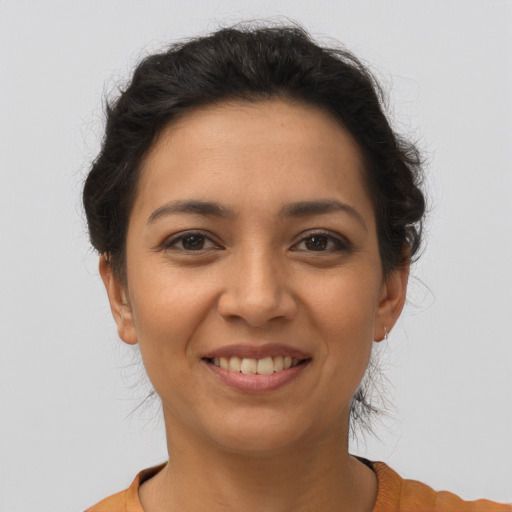Joyful latino young-adult female with short  brown hair and brown eyes
