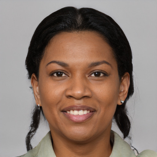 Joyful black young-adult female with medium  black hair and brown eyes