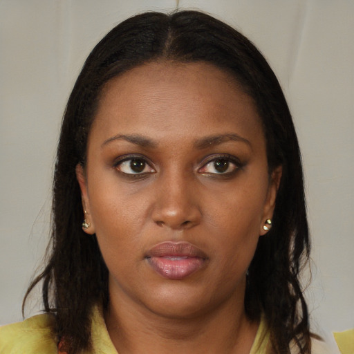 Neutral black young-adult female with long  brown hair and brown eyes