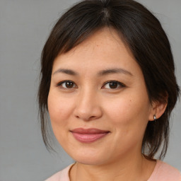 Joyful asian young-adult female with medium  brown hair and brown eyes