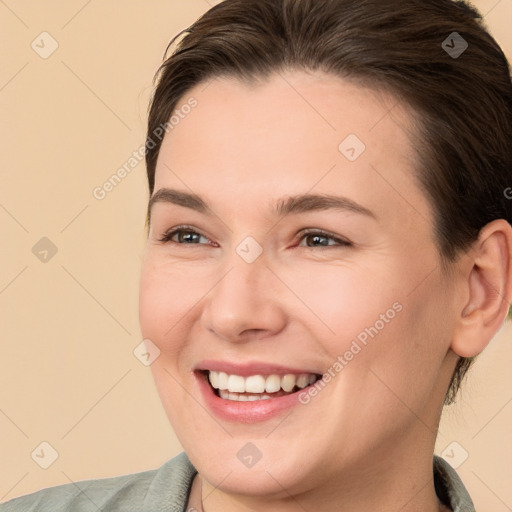 Joyful white young-adult female with short  brown hair and brown eyes