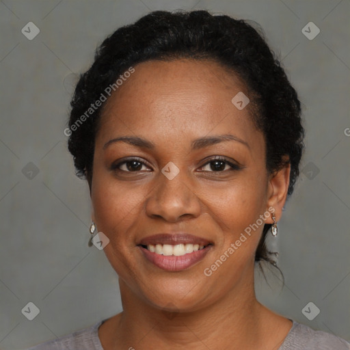 Joyful black adult female with short  black hair and brown eyes