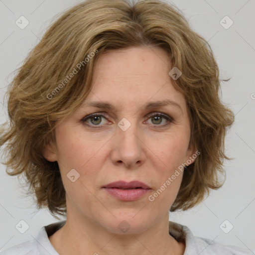 Joyful white adult female with medium  brown hair and green eyes