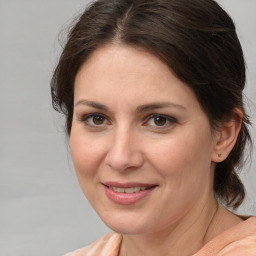 Joyful white young-adult female with medium  brown hair and brown eyes