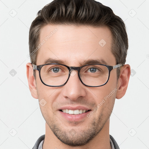 Joyful white young-adult male with short  brown hair and grey eyes