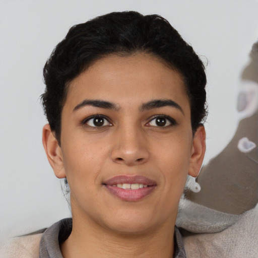 Joyful latino young-adult female with short  brown hair and brown eyes