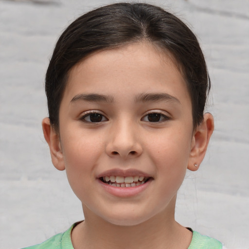 Joyful white child female with short  brown hair and brown eyes