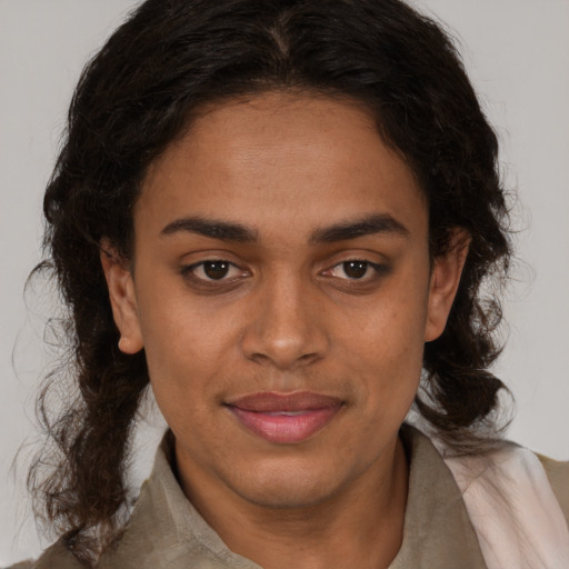 Joyful black young-adult female with medium  brown hair and brown eyes