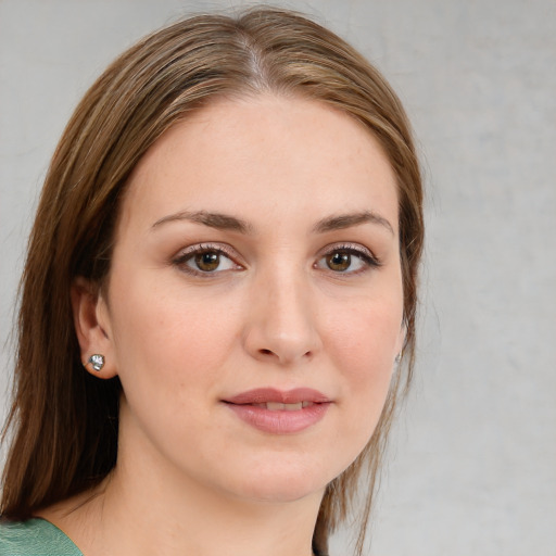 Joyful white young-adult female with medium  brown hair and green eyes